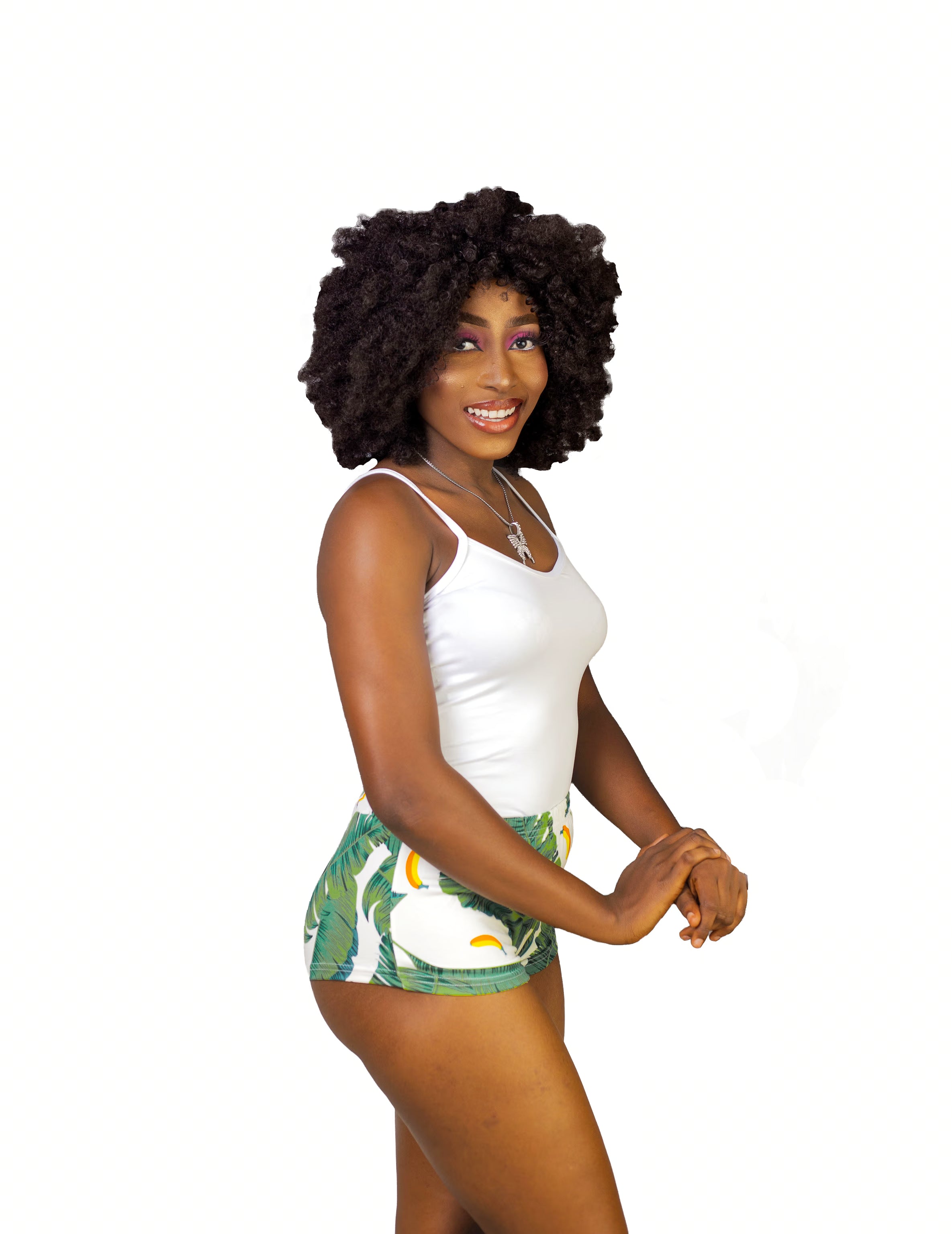 Woman wearing a white tank top and green leaf shorts sleepwear set on a white background