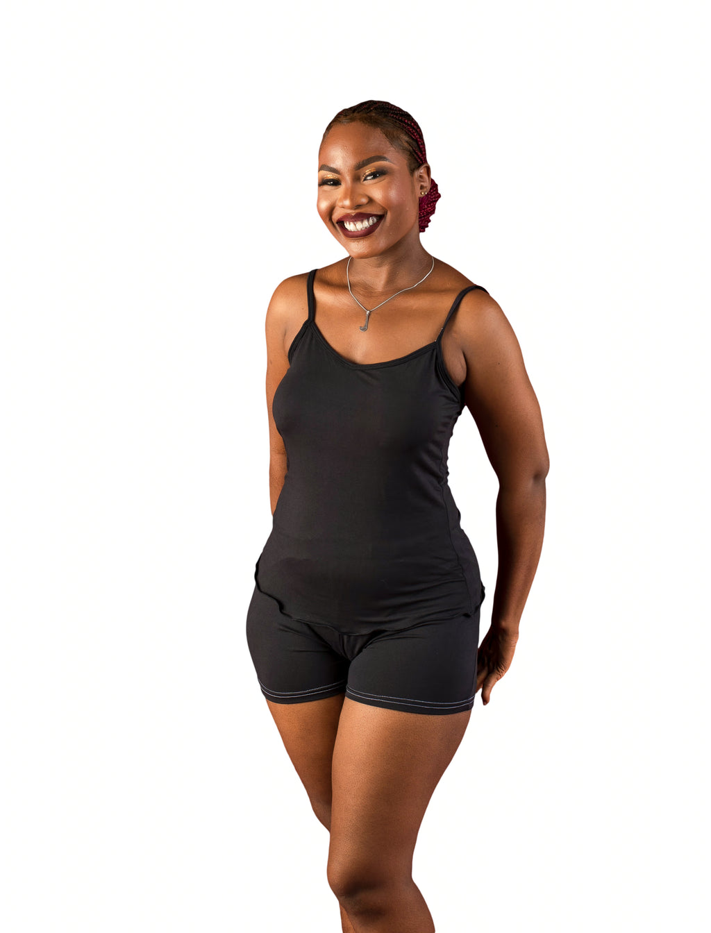 Woman wearing a black cami sleepwear top and shorts on a white background