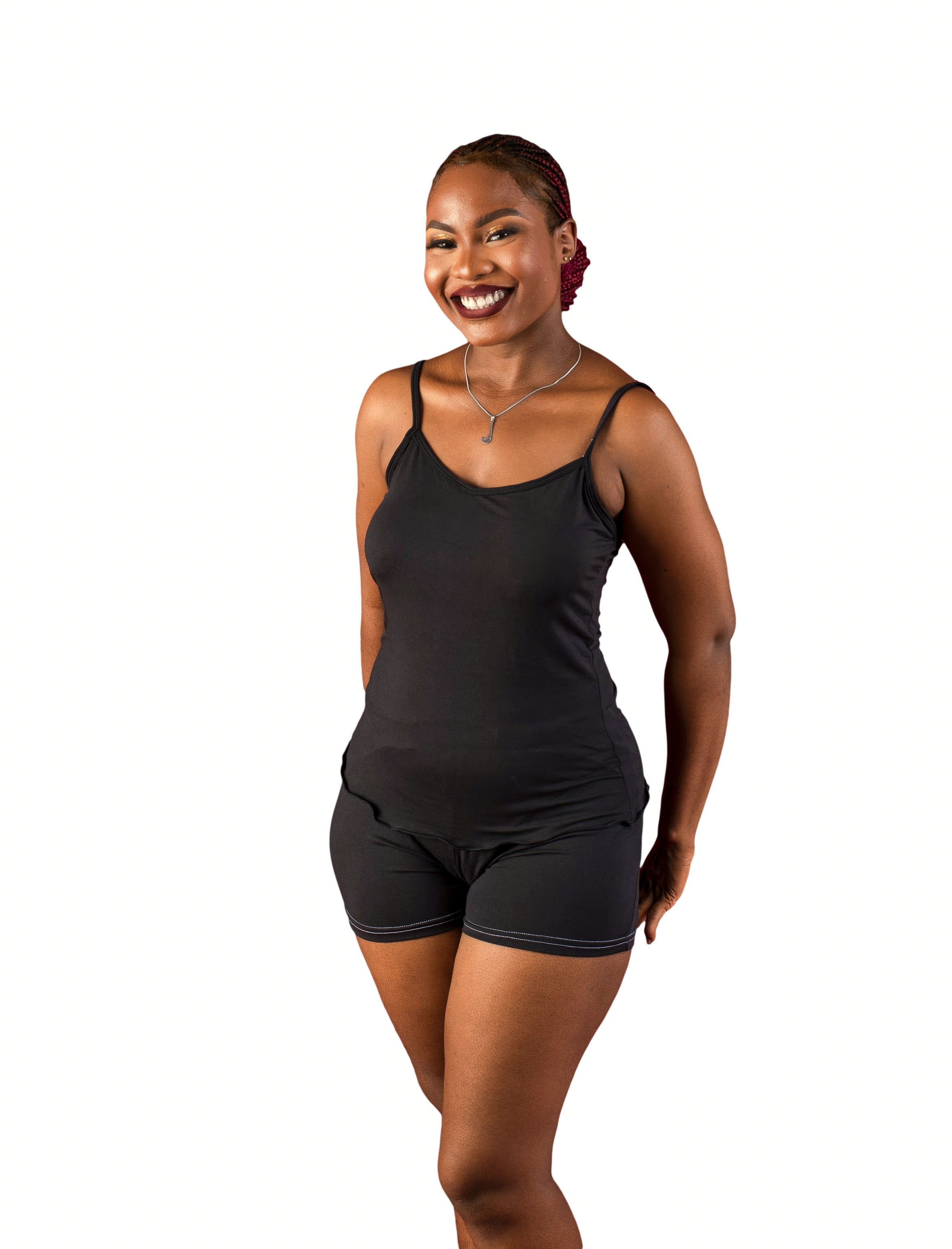 Woman wearing a black cami sleepwear top and shorts on a white background