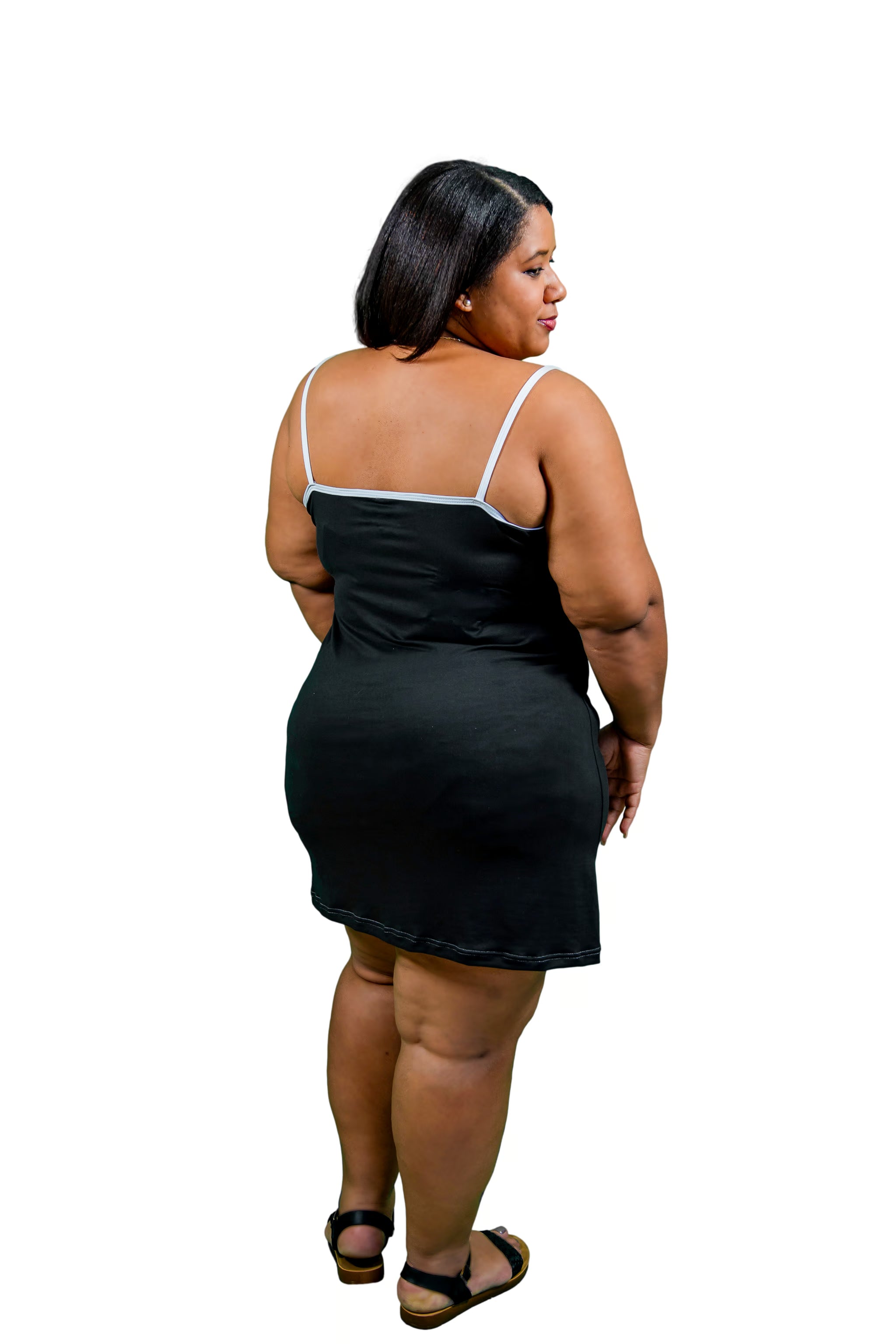 Woman wearing a black night gown  with white straps on a white background