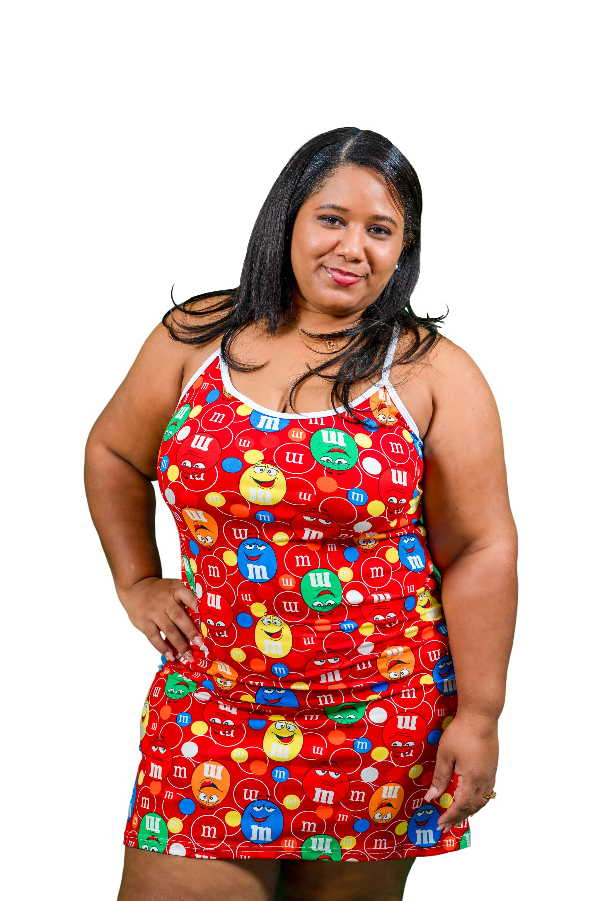 Woman wearing a colorful M+M-themed dress on a white background