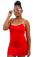 Woman wearing a red SLEEP dress and white glasses on a white background