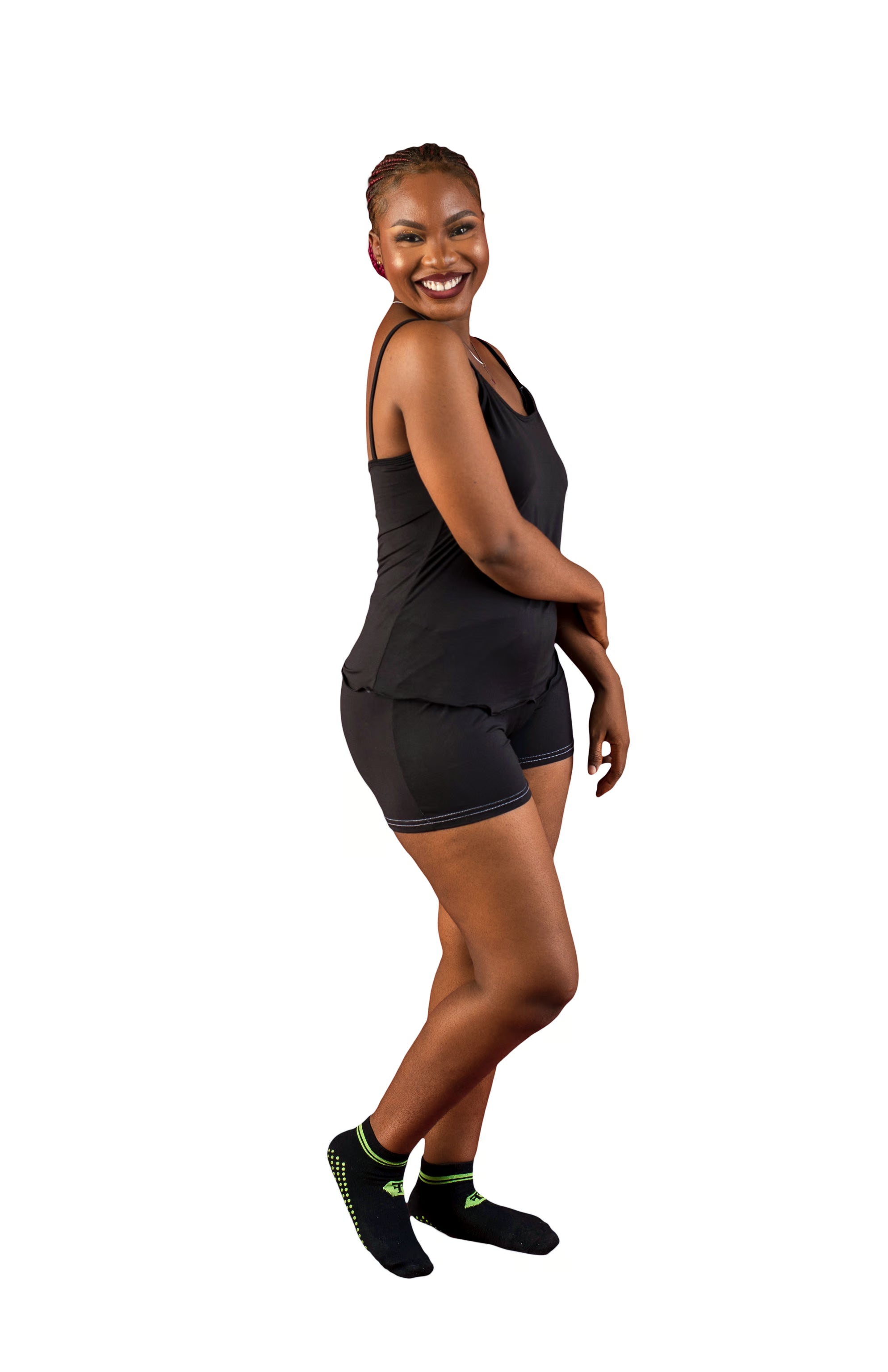 Woman wearing a black cami pajama set  on a white background