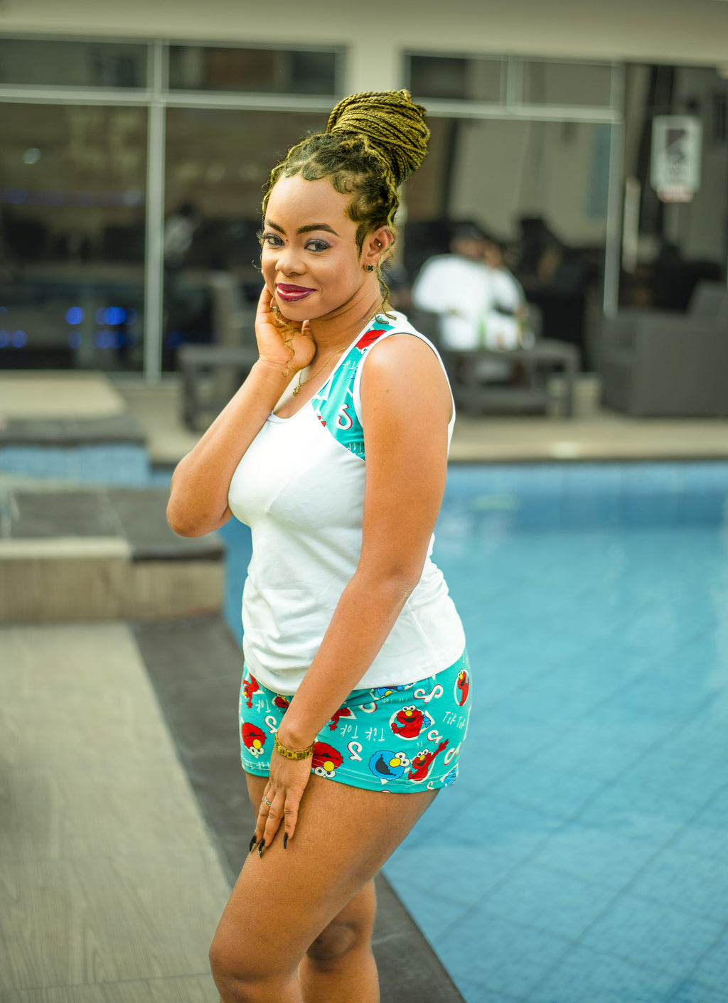 Woman in colorful Retro Pop Shorts sleepwear Set standing by a pool