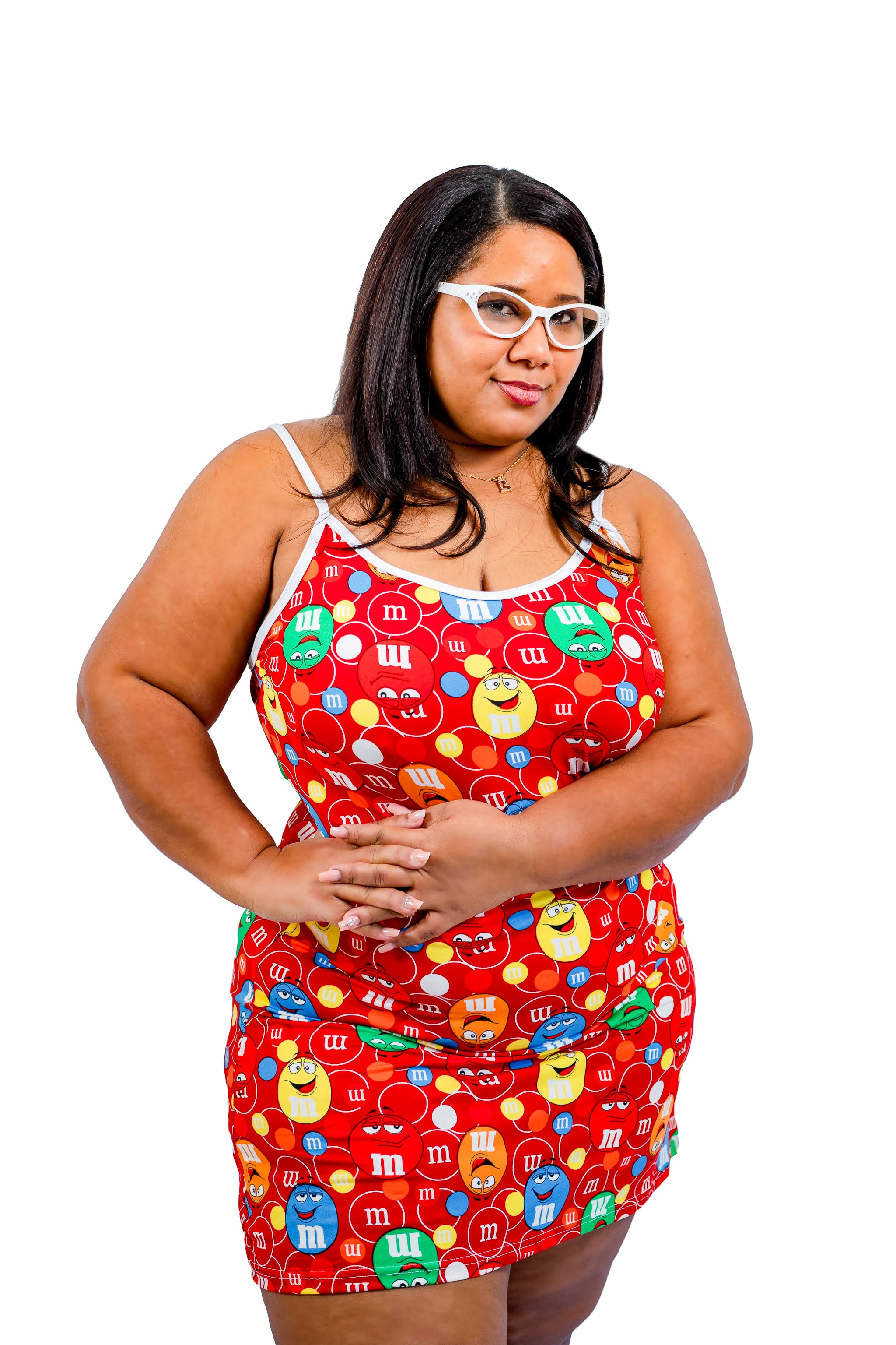 Woman wearing a colorful dress with candy pattern on a white background