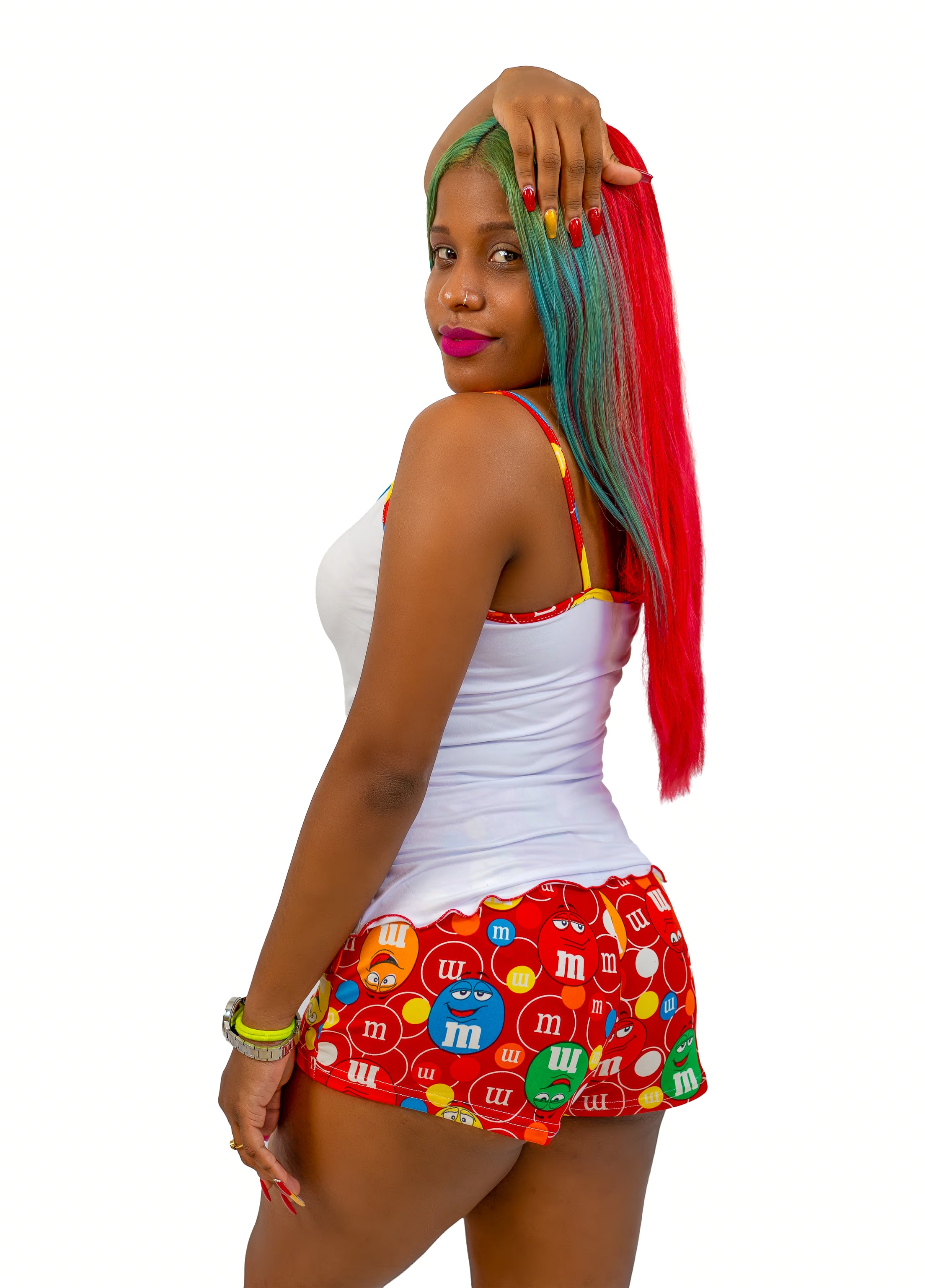 Woman wearing a colorful M&M-themed pajama short set on white background