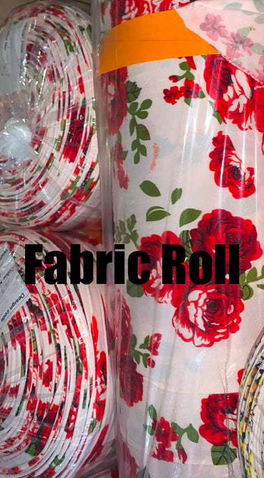 Fabric roll with red floral pattern and orange band, surrounded by other fabric rolls.