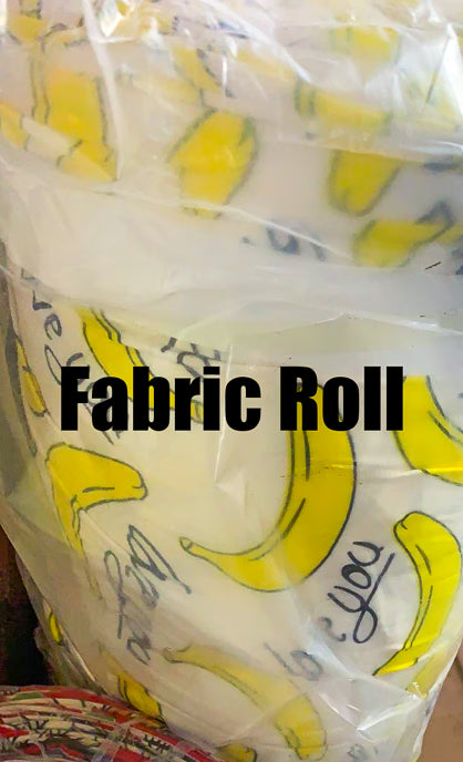 Fabric roll with banana pattern and text on a clear background