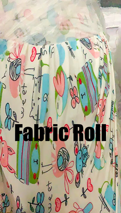 Fabric roll with colorful cartoon designs on a white background