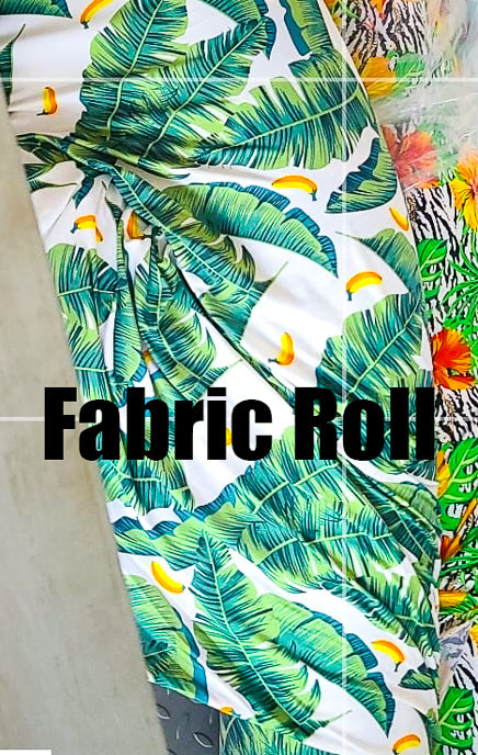 Fabric roll with tropical leaf pattern on a white background
