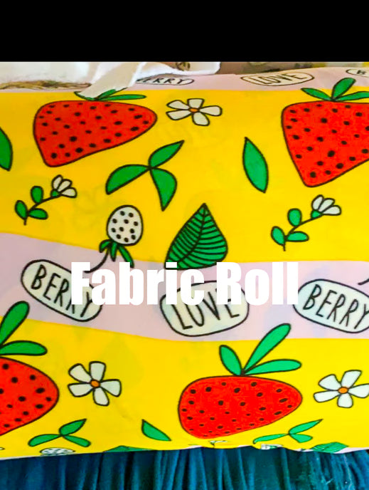 Fabric roll with strawberry pattern and text 'Fabric Roll' on a yellow background