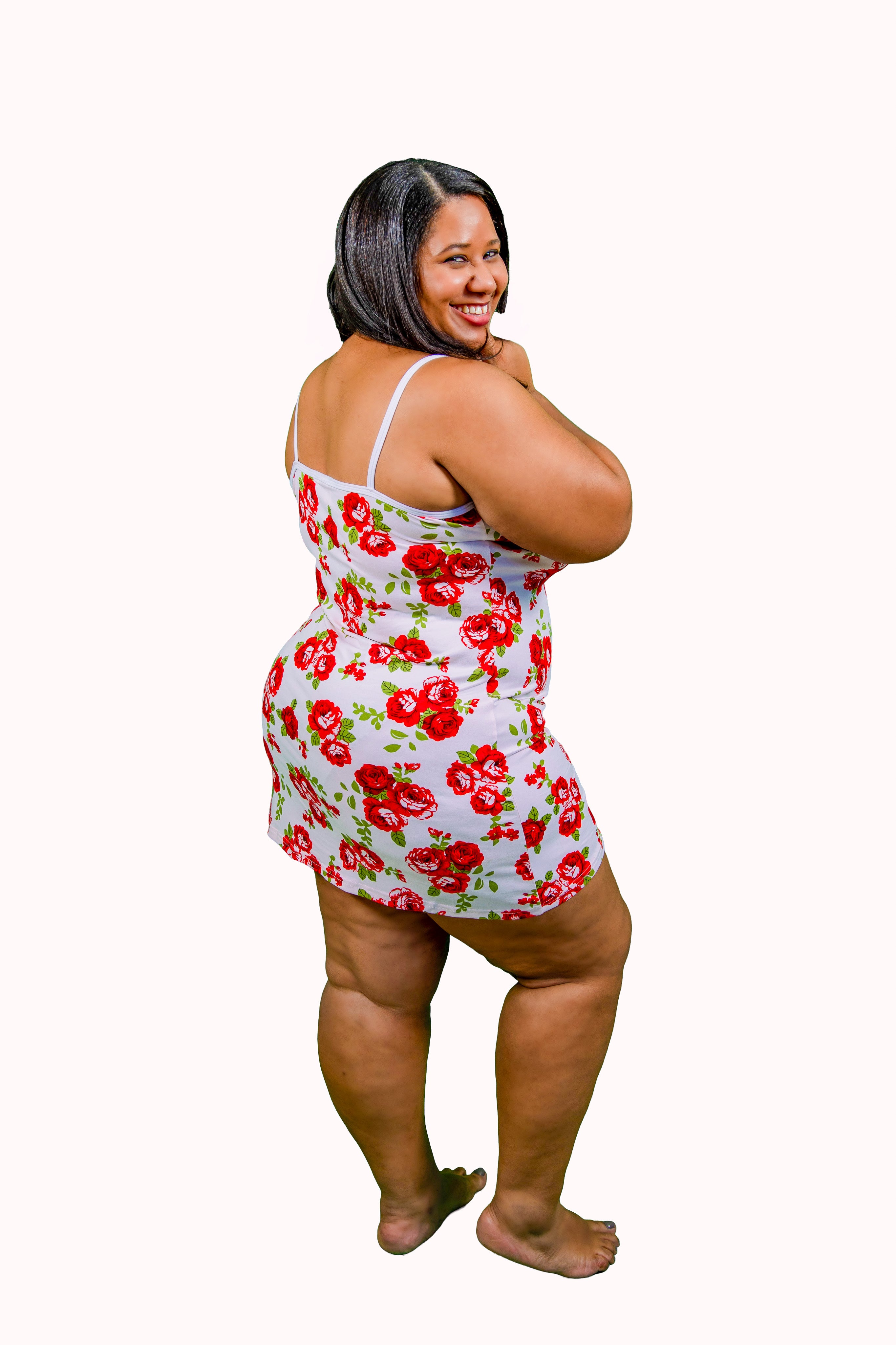 Woman wearing a floral nightgown on a white background