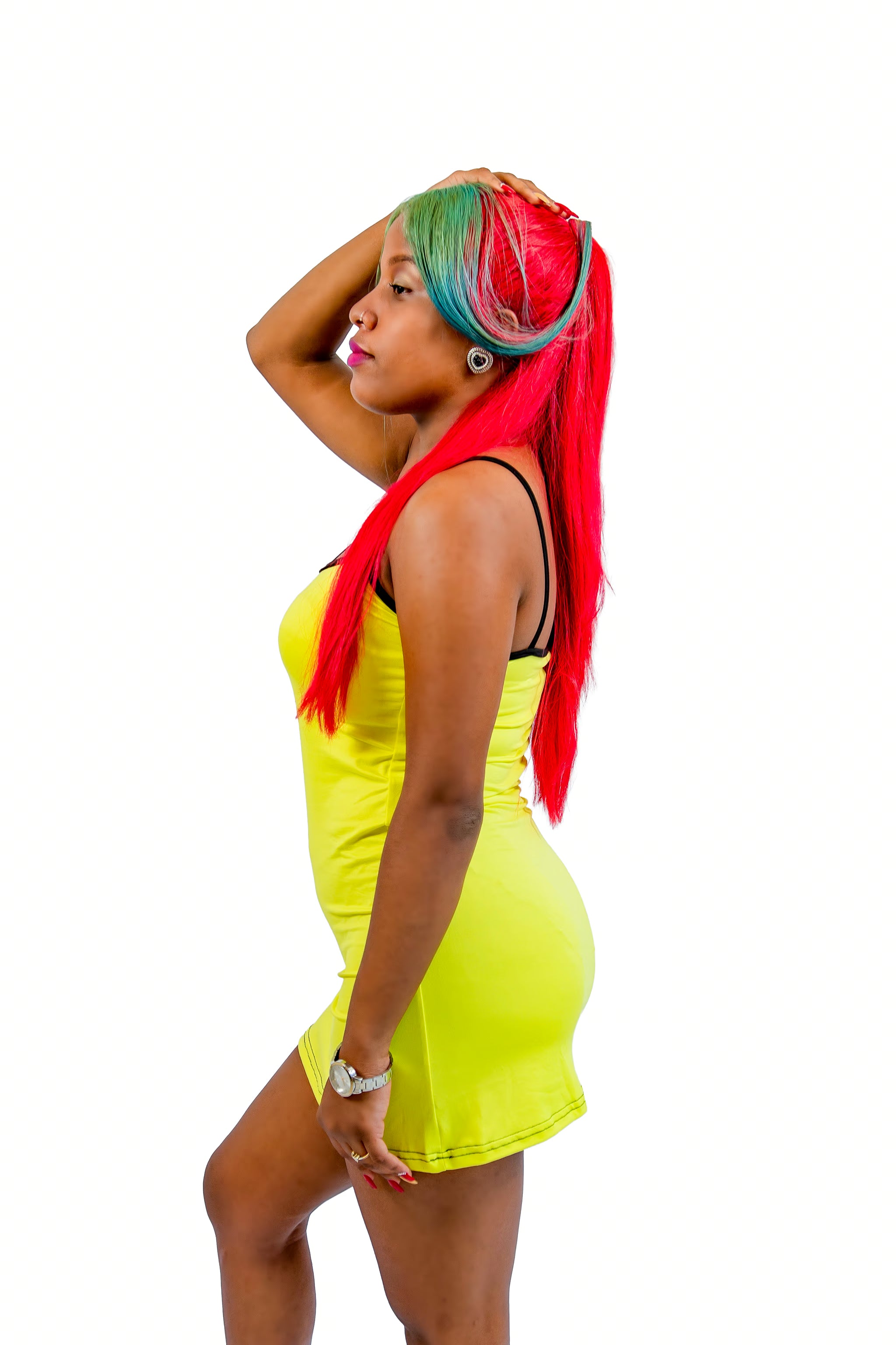 Woman with colorful red hair wearing a yellow nightgown on a white background